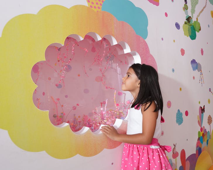 a child interacting with an exhibition