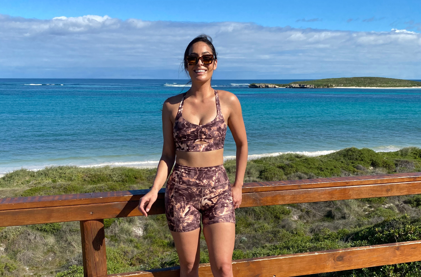Person standing in front of the ocean wearing active wear