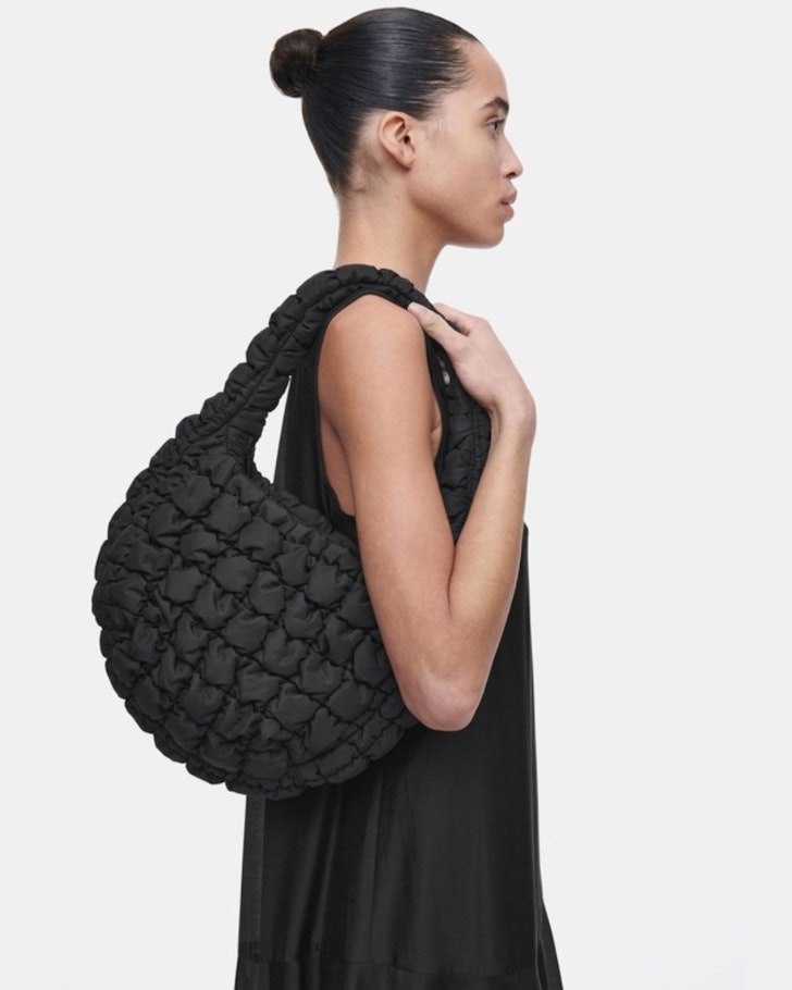 A woman models the COS Quilted Mini Bag one of the best gifts for her