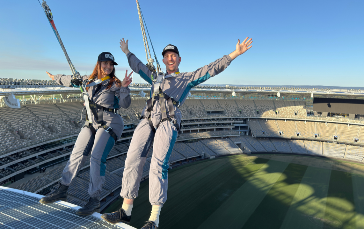 Two people standing on top of Optus Stadium