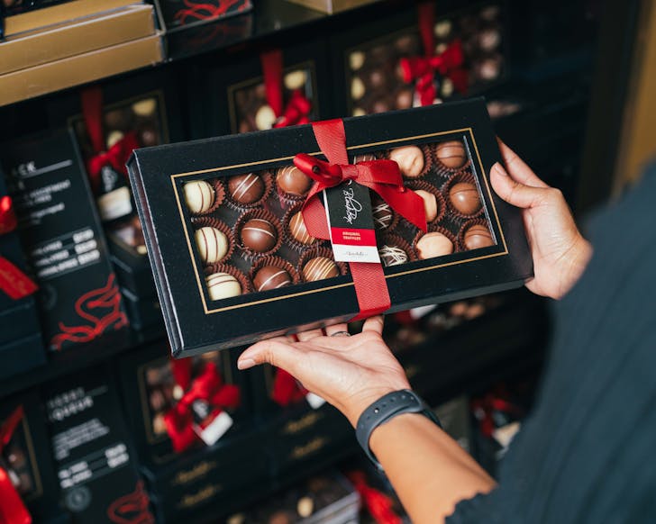 Hand holding chocolate box