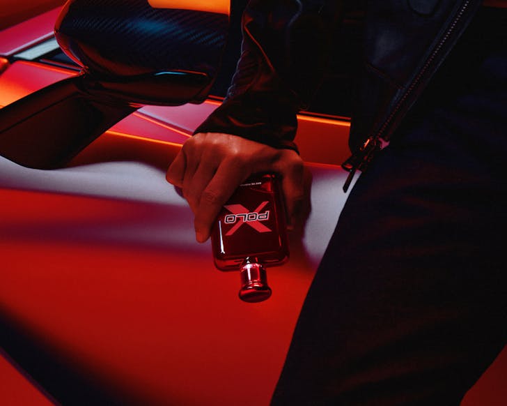 Person holding perfume bottle in pocket