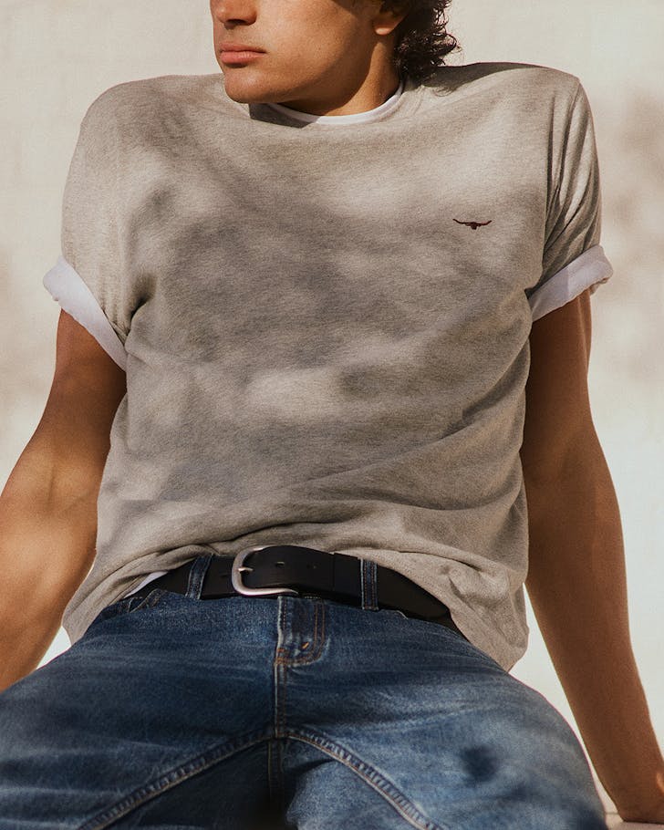 Someone relaxes in a double t-shirt.