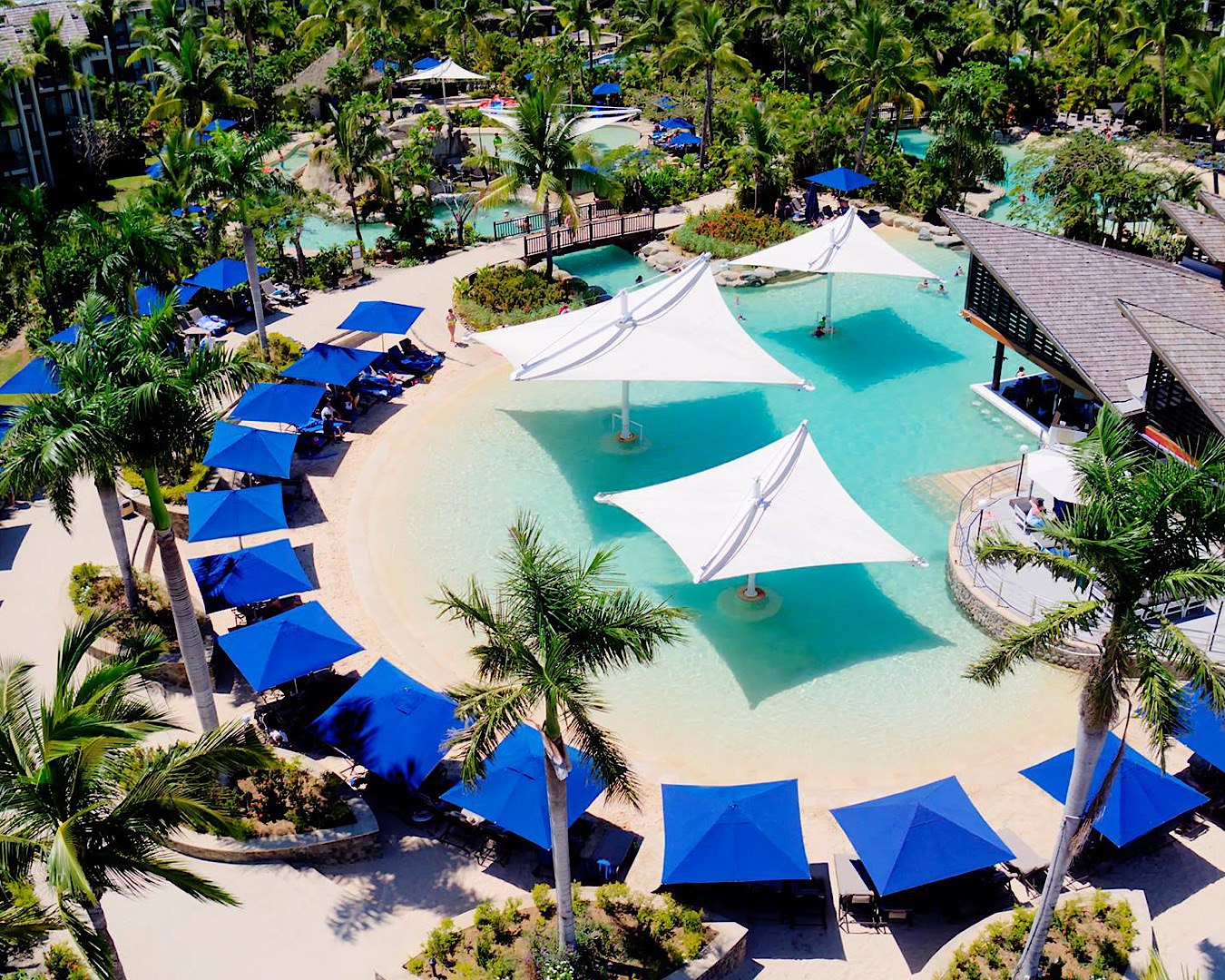 Aerial view looking onto Radisson Blu Fiji’s lagoon pools and lush gardens. 