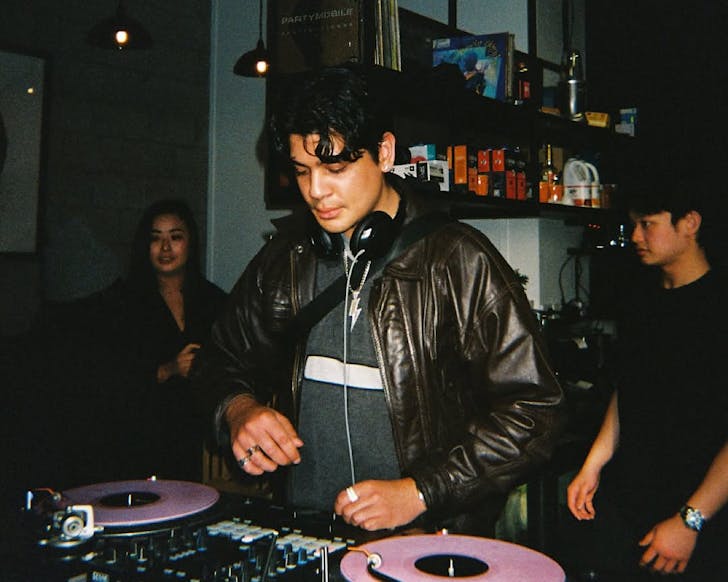 A man tries out mixing vinyls on the decks.
