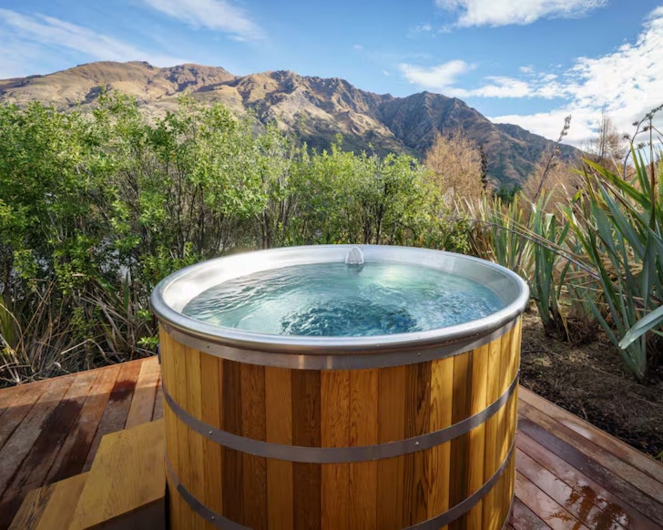 The hot tub with a mountain view at Redfern Retreat romantic stay Queenstown, New Zealand
