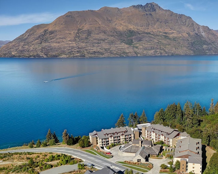 An aerial view of Rendezvous Heritage Hotel with a mountain in the background, Queenstown