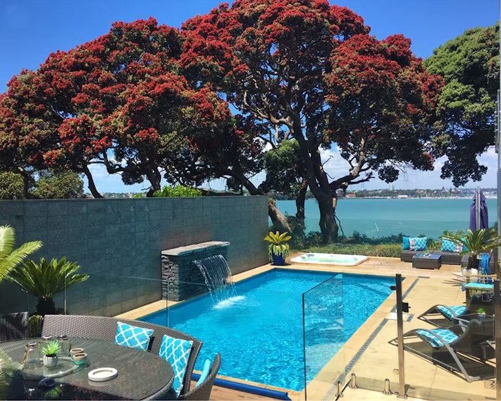 The lush outdoor pool at Resort Style Living one of the best Auckland Airbnbs