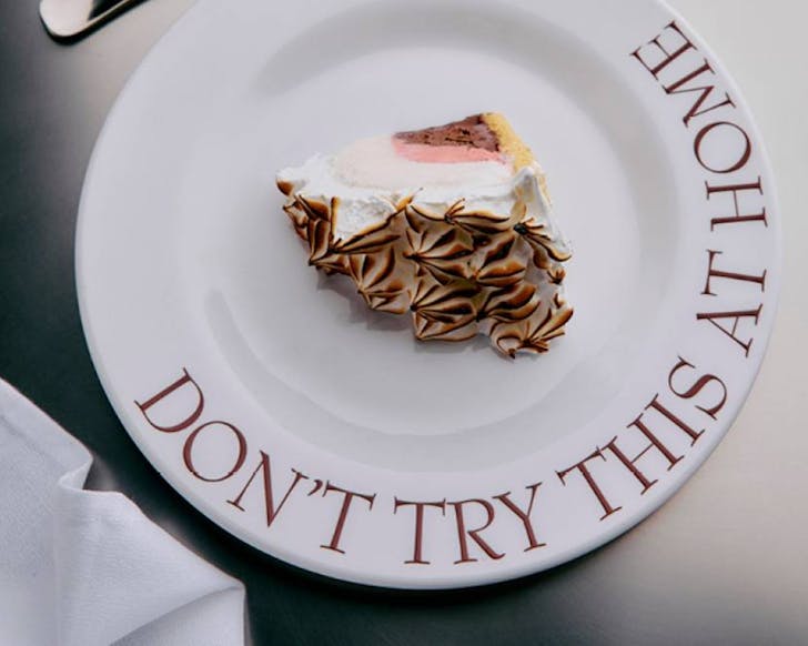 A plate topped with a slice of Bombe Alaska. 