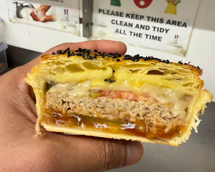 A cross-section of a vegan cheese burger pie. 