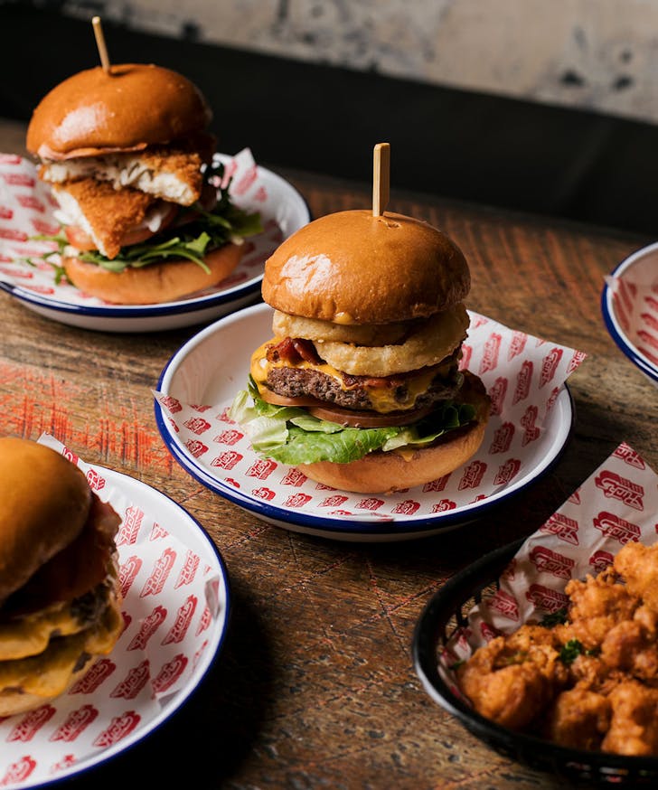a table full of burgers