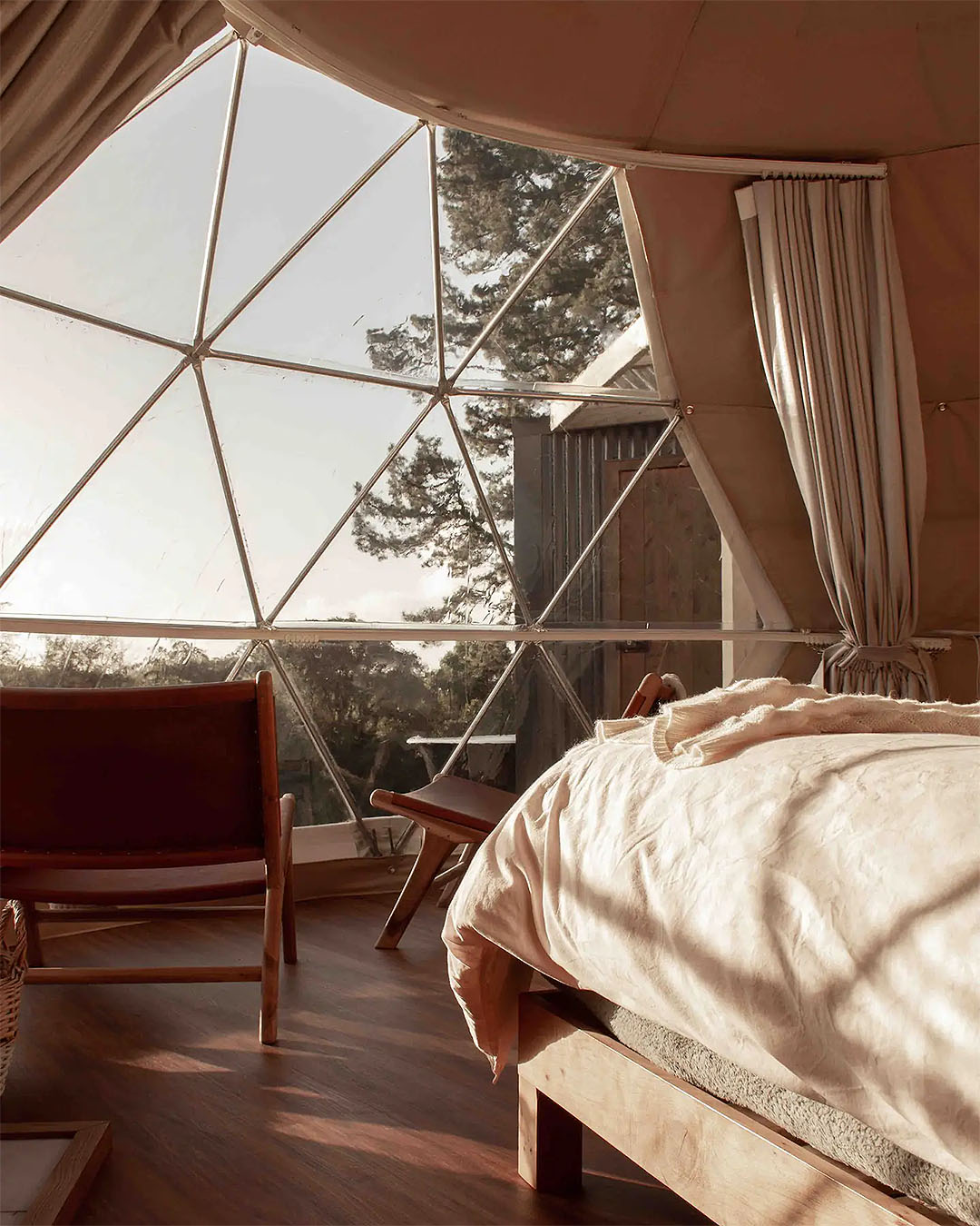 A cosy geodesic dome is seen from the inside, bathed with light.