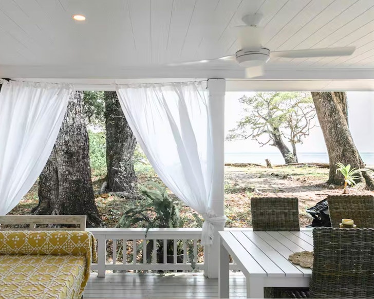 A view of the sand and sea from the deck of Rob’s Beach Shack one of the best Port Douglas Airbnbs