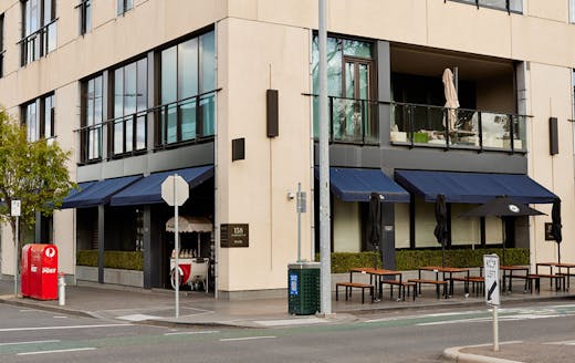 The exterior of a restaurant shot from the street. 