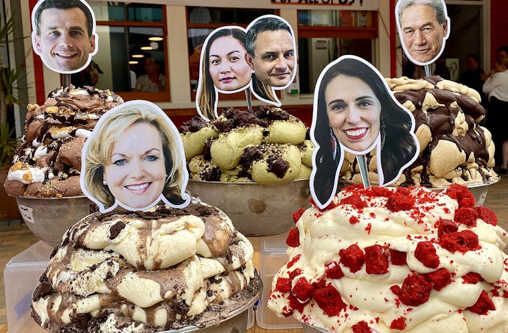 Tubs of delicious looking gelato stacked high with politician's heads on sticks poking out of the top.
