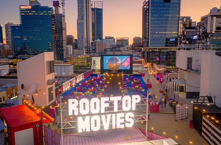 A Perth rooftop cinema with colourful bean bags sitting atop a building.