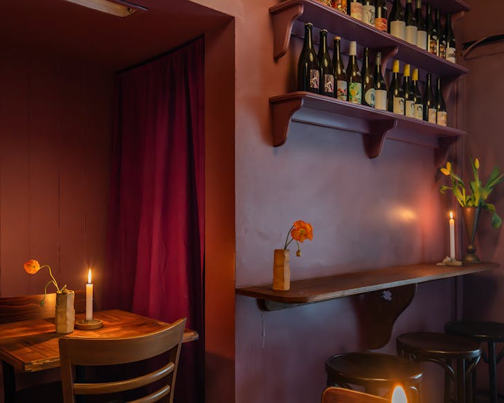 A shot of the beautiful, dark lilac interiors and empty tables at Roses Dining Room. 