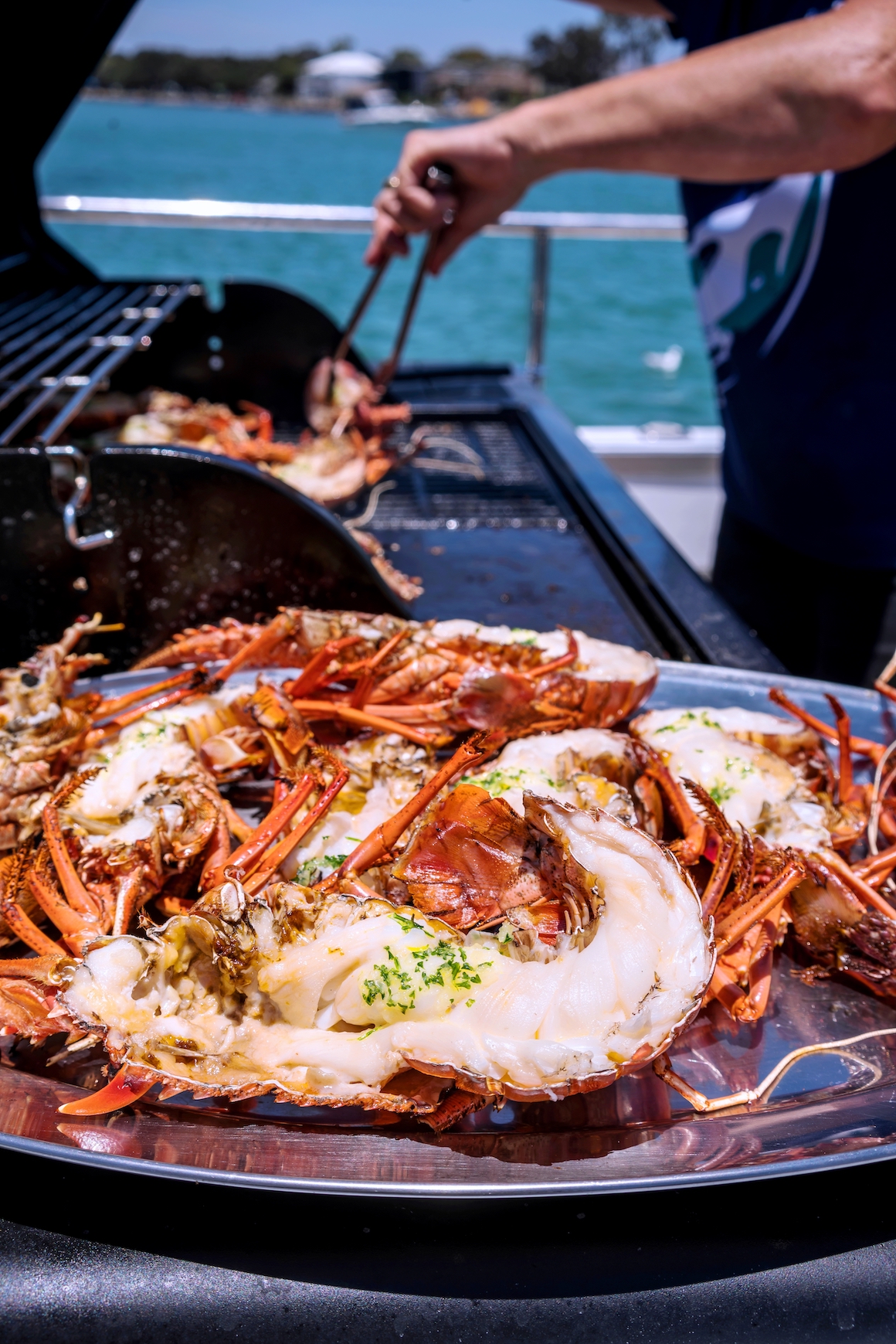 Crays being cooked on the BBQ onboard Rottnest Cruises Seafood Experience