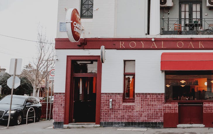 A white and red Fitzroy pub with a large Carlton Draught beer sign. 