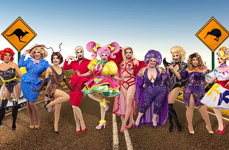 A group of Ru Paul contestants in their outfits on a stretch of Australian outback road. 