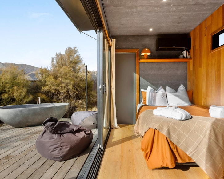 The bedroom and outdoor bath at Rua best Airbnbs outdoor baths hot tubs New Zealand