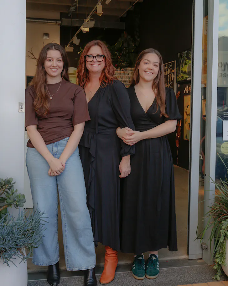 Ruby, Liss and Lucy Wallace stand in the doorway to Turua Gallery