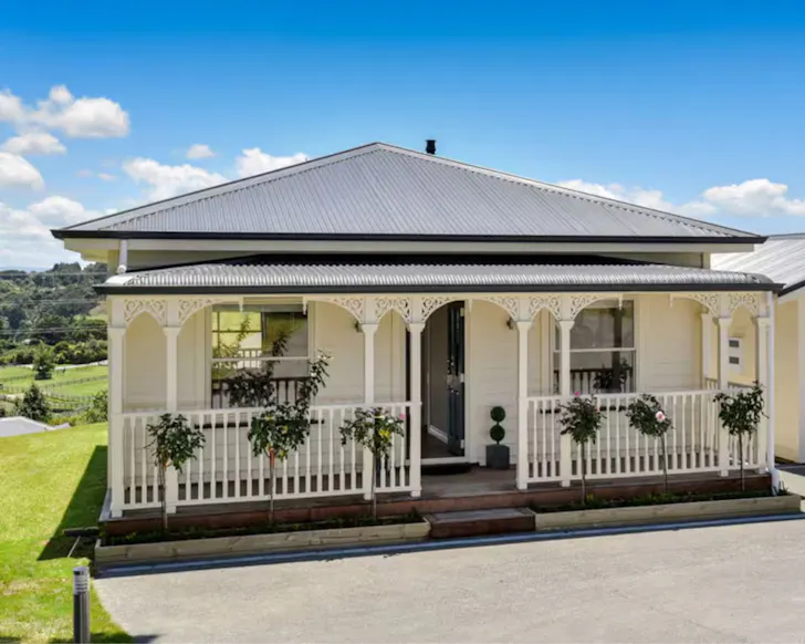 A view of the pretty white frontage of Rural Luxury one of the best Auckland Airbnbs