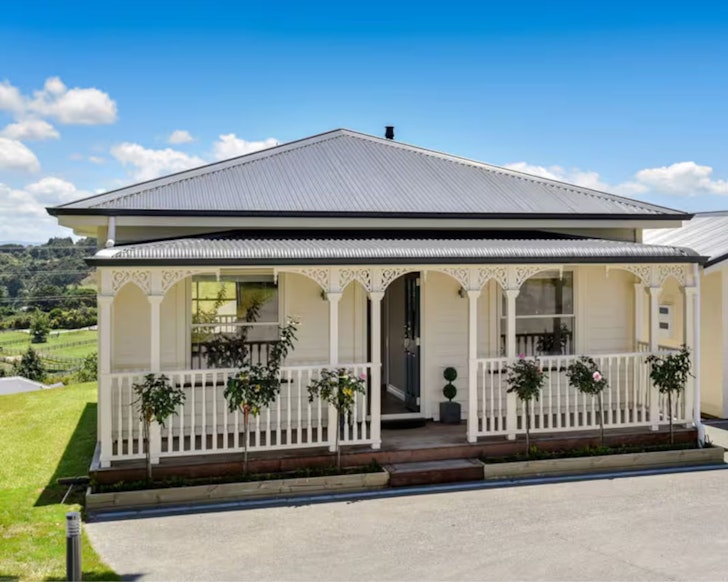 A view of the pretty white frontage of Rural Luxury one of the best Auckland Airbnbs