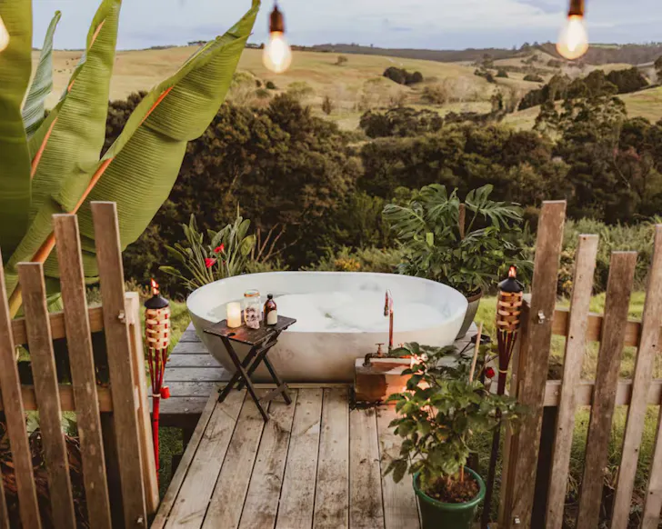 The outdoor bathtub at Ruru Retreat Tiny one of the best romantic stays in New Zealand