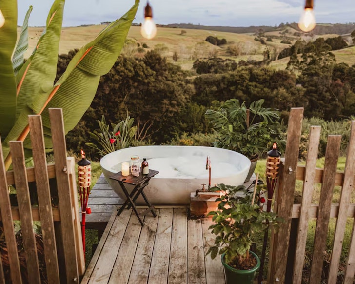The outdoor bathtub at Ruru Retreat Tiny one of the best romantic stays in New Zealand