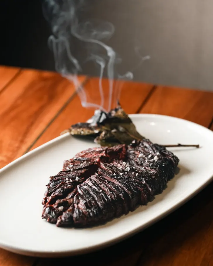 A steaming, char-grilled steak at Ruse Bar & Brasserie.