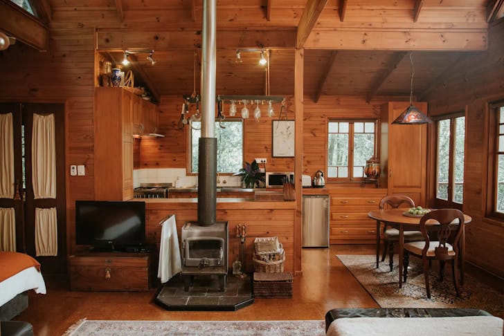 a wooden cabin with fireplace