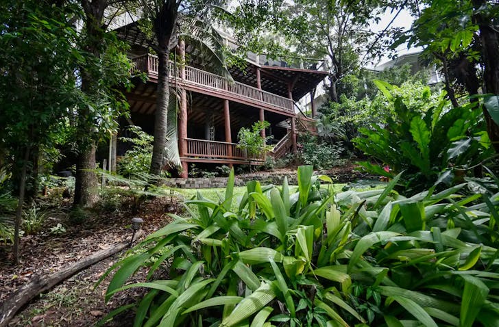 a multi-storey house surrounded by greenery