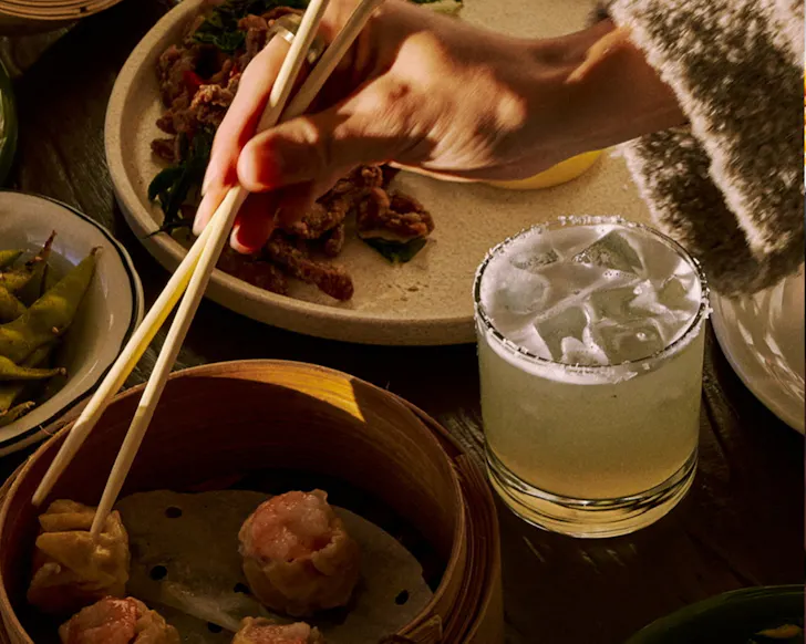 Glass and hands over with chopsticks