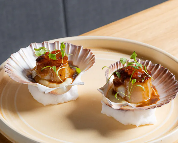 two scallops on a plate