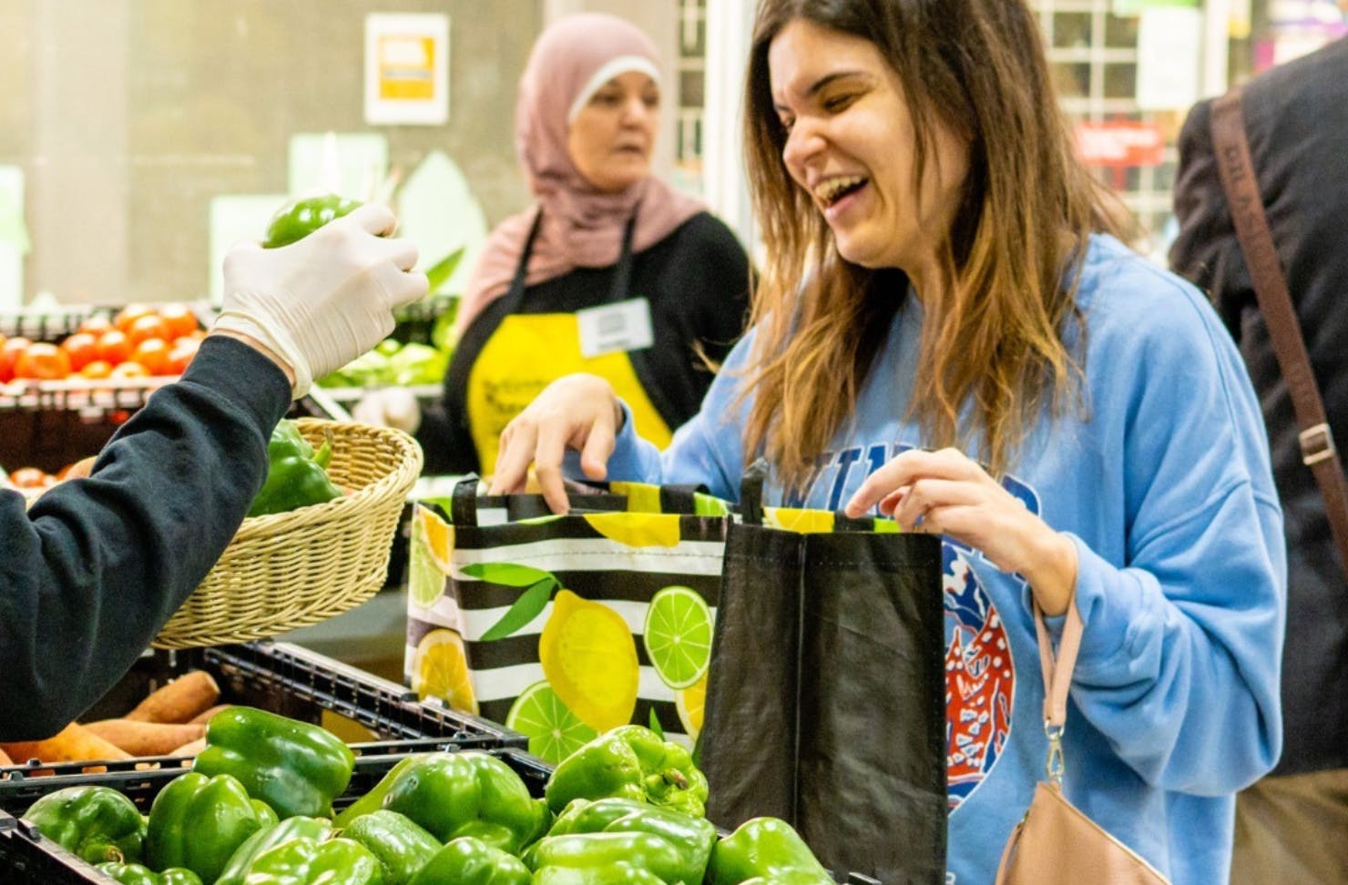 Person collecting vegetables from market