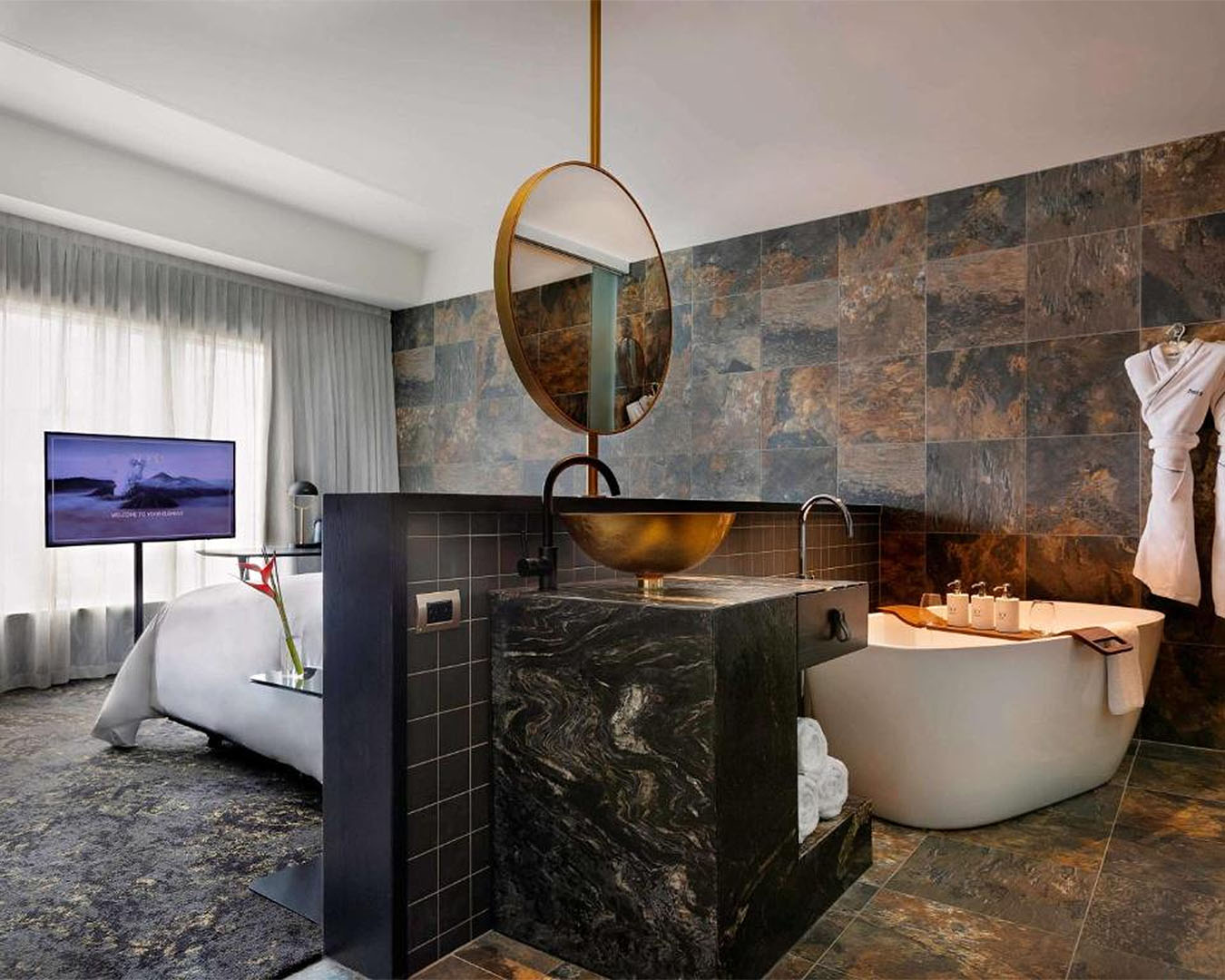 A boujee little room showing an open plan bathroom and bedroom at So/ Auckland, one of the best hotels in Auckland.