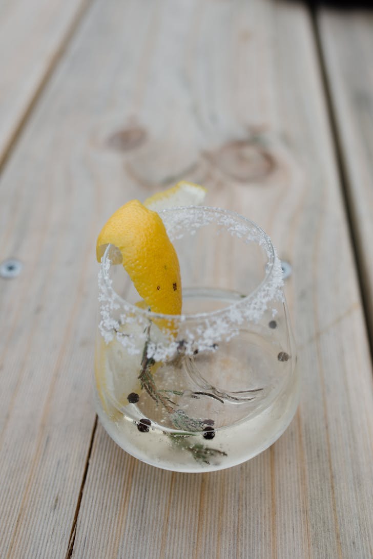 a close-up of a cocktail adorned with a lemon wedge