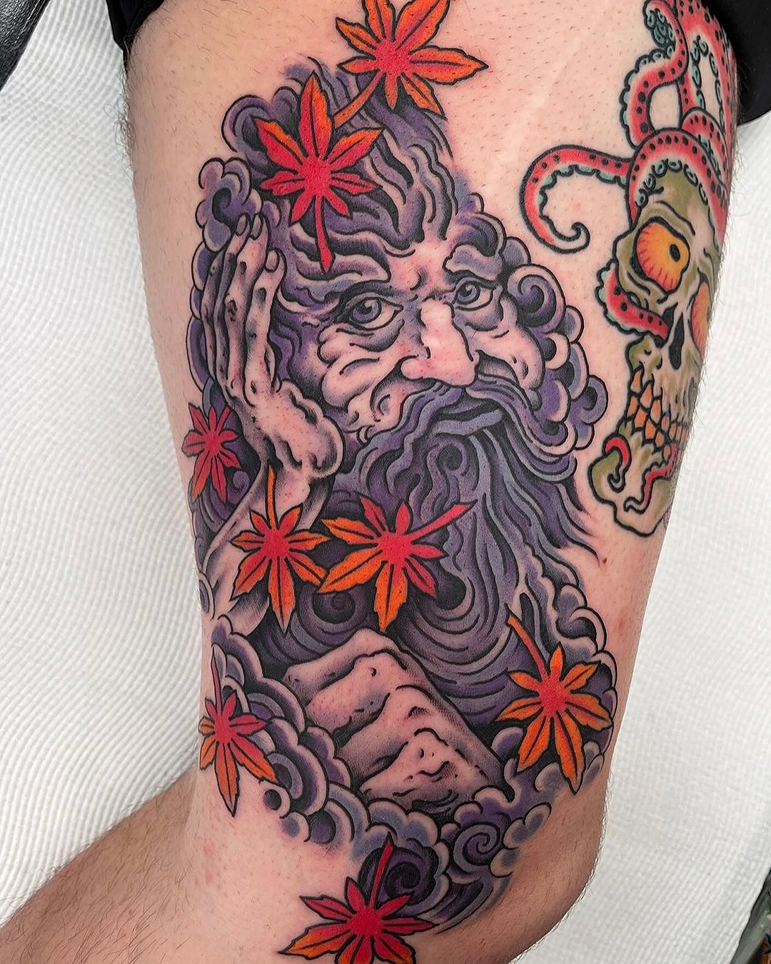 Someone with a colourful man with a beard on their leg.