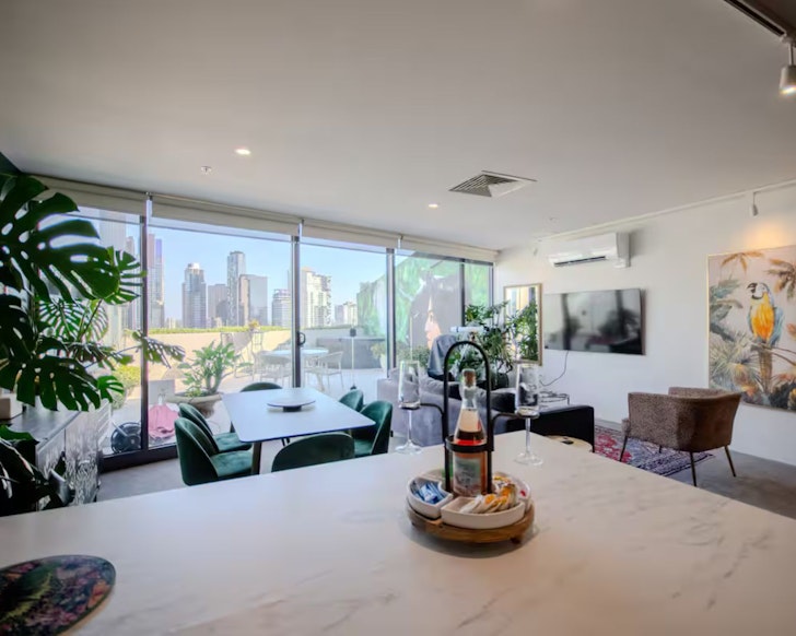 A view of the living space looking out to Melbourne skyline at Safari in City one of the best Airbnbs