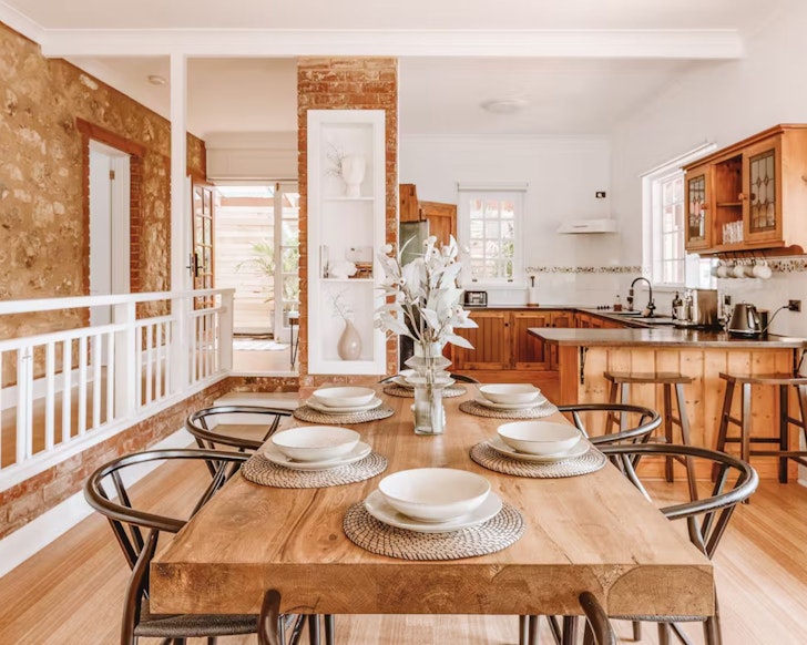 A view of the living and kitchen space and stone walls at Sage one of the best Airbnbs near Adelaide
