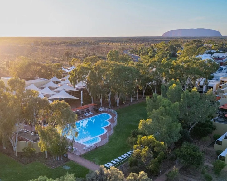 An aerial view of Sails In The Desert with Uluru on the horizon, one of the best hotels in Australia