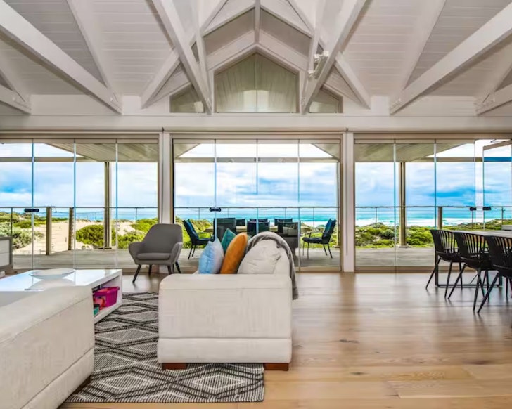 The sea view from the huge windows in the living space at Sand, Sea & Sunsets one of the best large group Airbnbs Victoria