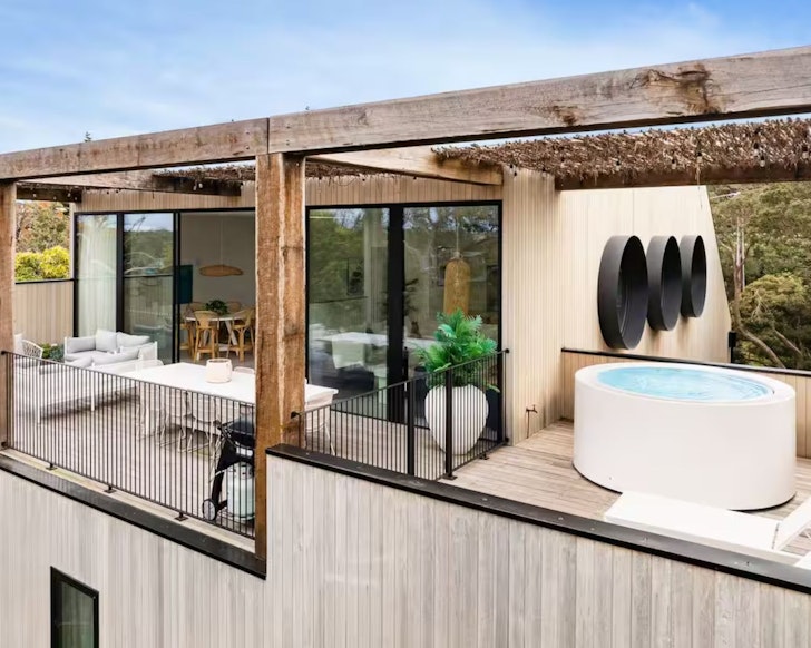 The outdoor spa with portholes above at Santorini Blue luxury Airbnb accommodation Mornington Peninsula