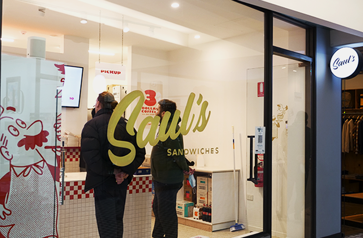 The shop front of Sauls with white paint and a gold Saul's logo on it