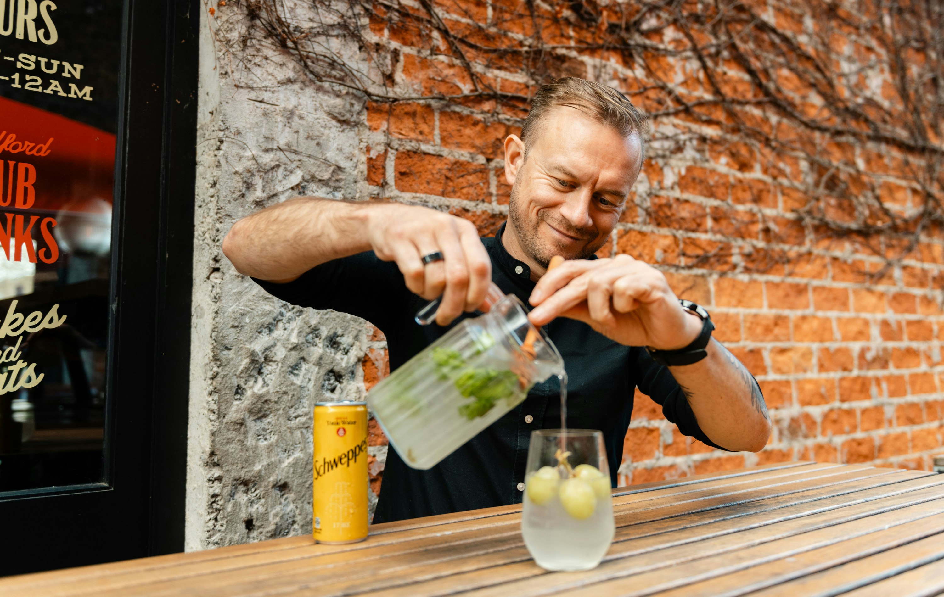 JC, creative director at Bedford Soda & Liquor pours the Sauvi Spritz cocktail into a glass