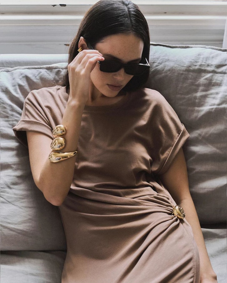 A woman in sunglasses wears the Noah The Label Sculpted Cuff one of the best gifts for her