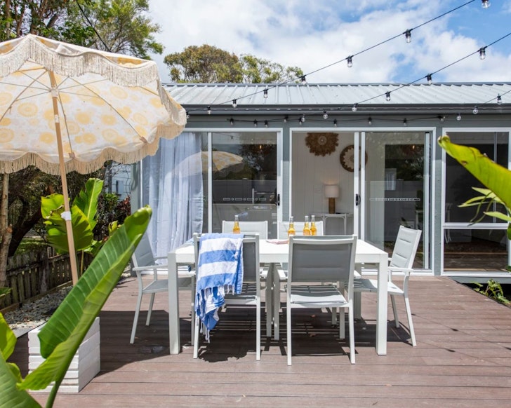 The outdoor deck at Sea Breeze Cottage one of the best Yamba Airbnbs