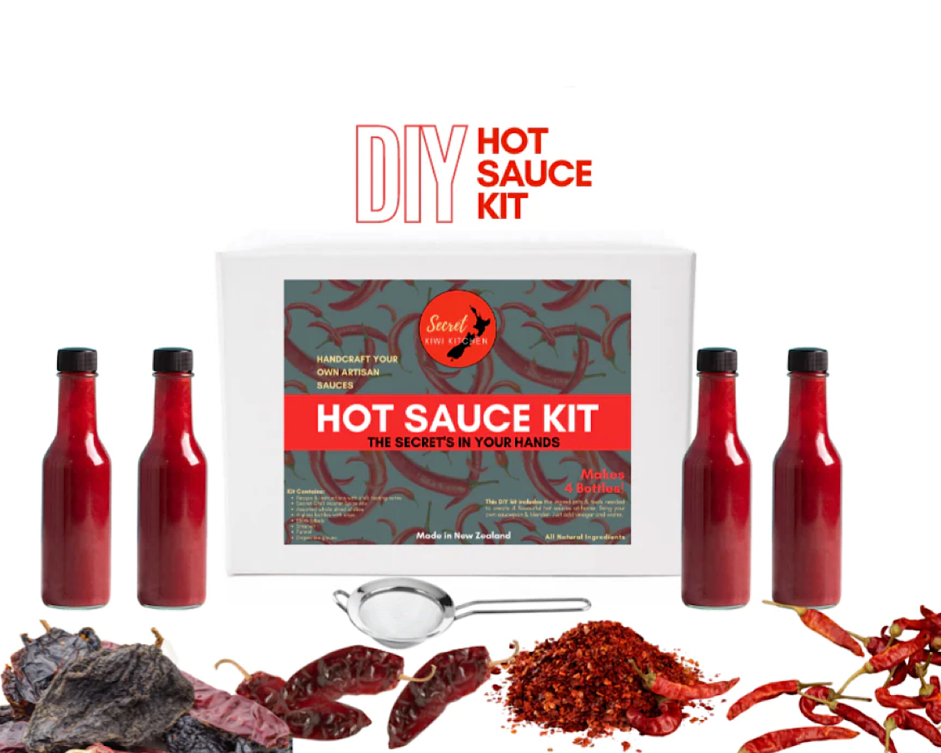 DIY Hot Sauce Kit box with a bunch of bottles filled with hot, red sauce and a load of chillies. 