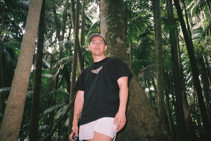 person standing in forest looking at camera